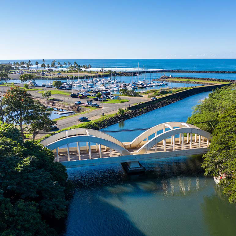 A drone shot of the Haleiwa bridge and harbor from above.