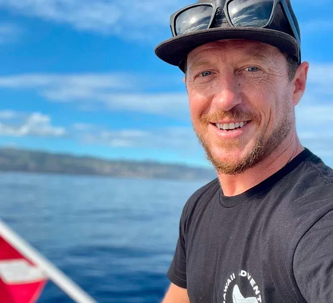 Headshot of Hawaii Adventure Diving captain Ro O'Rourke looking toward the camera on the Hawaii Adventure Diving boat.